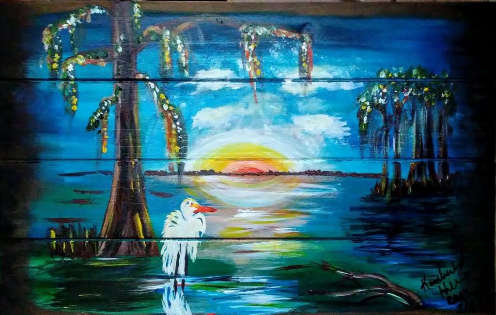 White egret standing in a Louisiana bayou at sunset with cypress trees, painted on wood